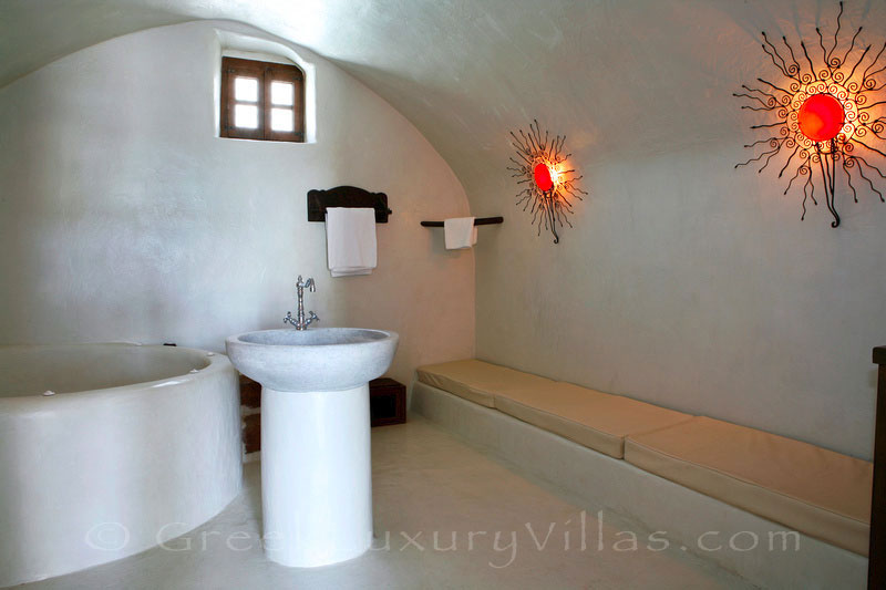 A luxurious bathroom in a villa with a pool in a traditional village in Santorinii