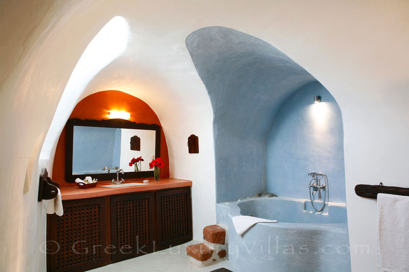 A bathroom of a traditional village house with a pool in Santorini