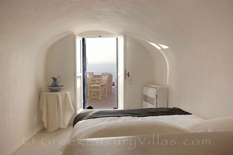 An aegean bedroom of a mansion luxury villa in Oia, Santorini