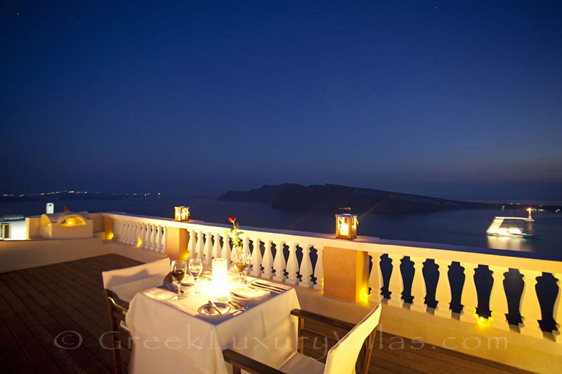 Dinner at sunset having a panorama view from a luxury villa in Oia, Santorini