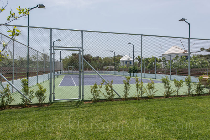private tennis court at villa with swimming pool in Crete