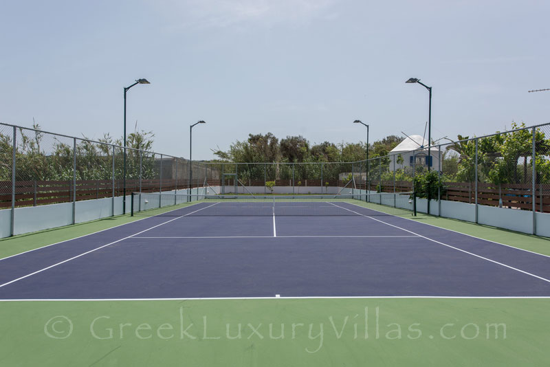 flood light private tennis court at villa with swimming pool