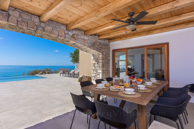 Outdoor dining in beachfront luxury villa