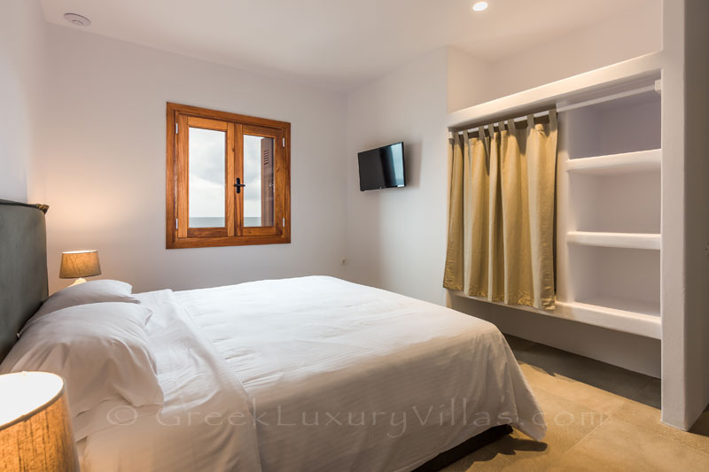Bedroom in an absolute beachfront villa with a pool