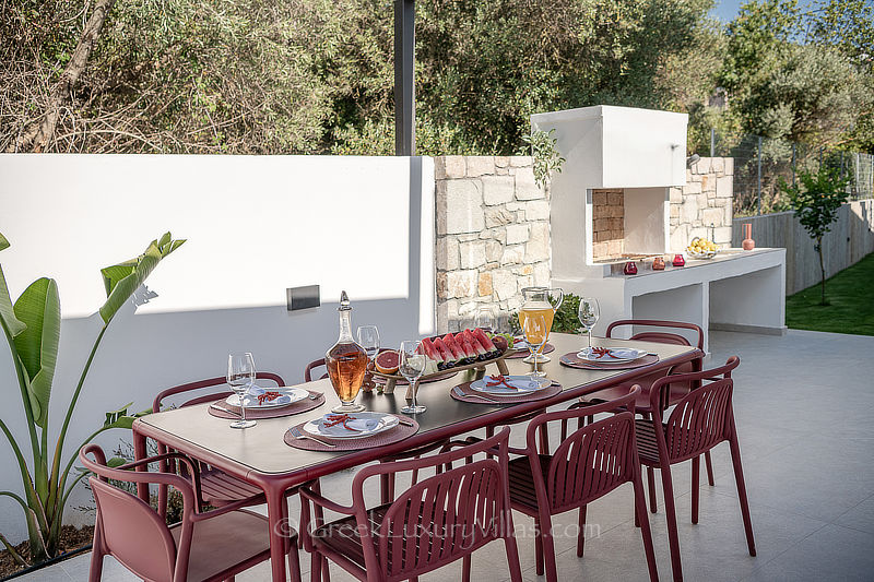outdoor dining by the pool in a holiday villa in Crete