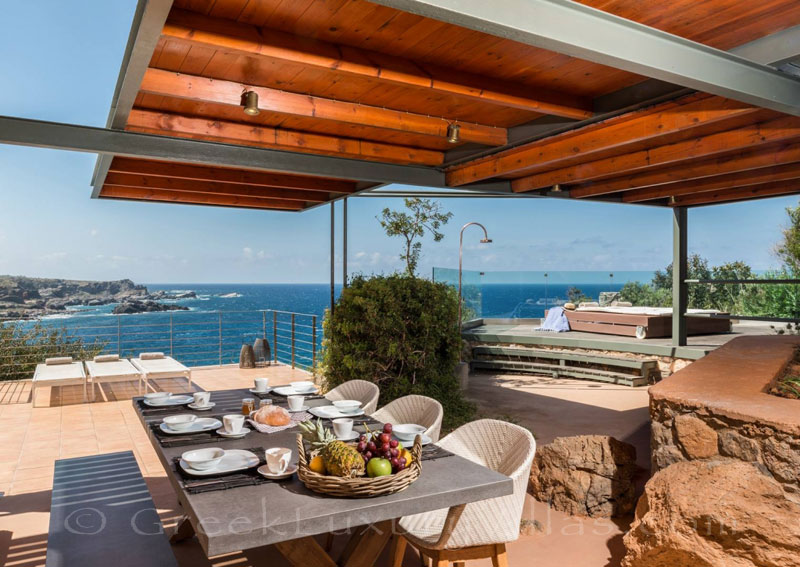 View from outdoor dining area of villa with pool in Crete