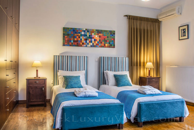 Single beds bedroom of family villa in Crete