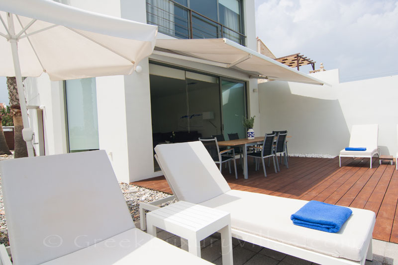 The sunny deck of a beachfront villa in Maleme, Crete