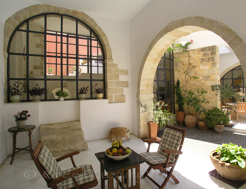 Dining outside at an exclusive historic villa in a traditional village of Crete