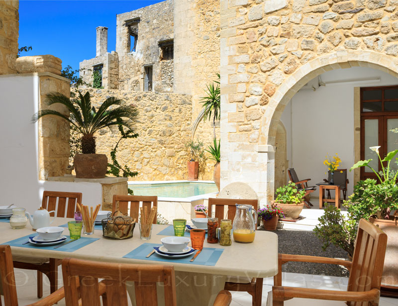 Dining outside at the exclusive historic villa in a traditional village of Crete
