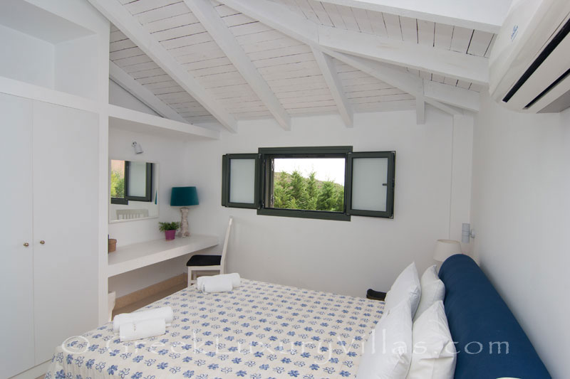 A bedroom of a modern, two bedroom villa with a private pool in Kefalonia