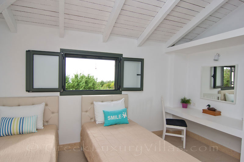 A bedroom of the modern, two bedroom villa with a private pool in Kefalonia