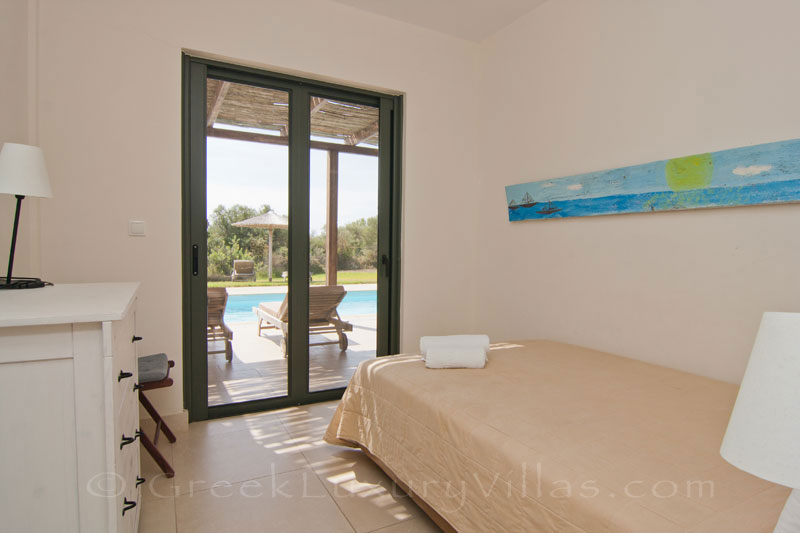 A bedroom in the modern, three bedroom villa near the beach in Kefalonia