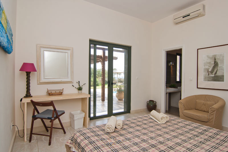 A bedroom in a modern, three bedroom villa near the beach in Kefalonia