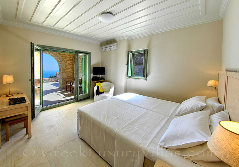 A bedroom in the luxurious villa with a pool and seaview in Lefkaka
