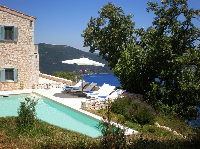 The garden of a villa with a pool and sea view in Lefkas