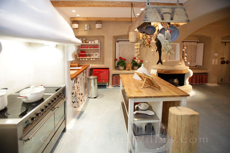 A stylish open plan kitchen os a luxury villa with a pool