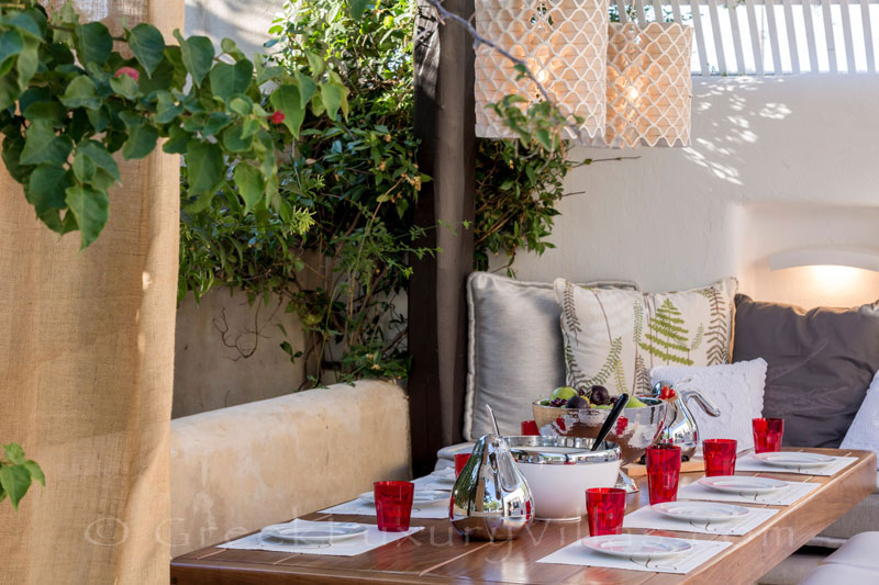 Outdoor dining at a luxury villa with a pool in Naxos