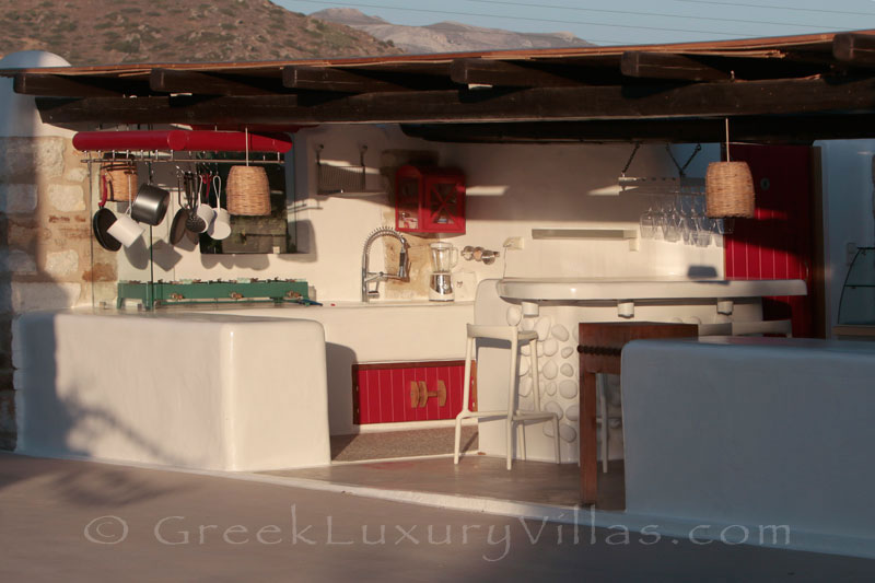An outdoor kitchen at a luxury villa with a pool in Naxos