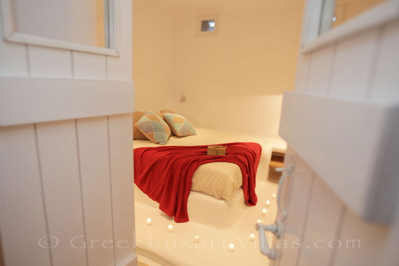 A bedroom downstairs in a luxury villa with a pool in Naxos