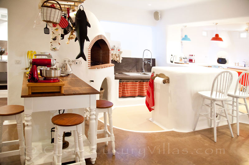 The big professional kitchen of a luxury villa with a pool in Naxos