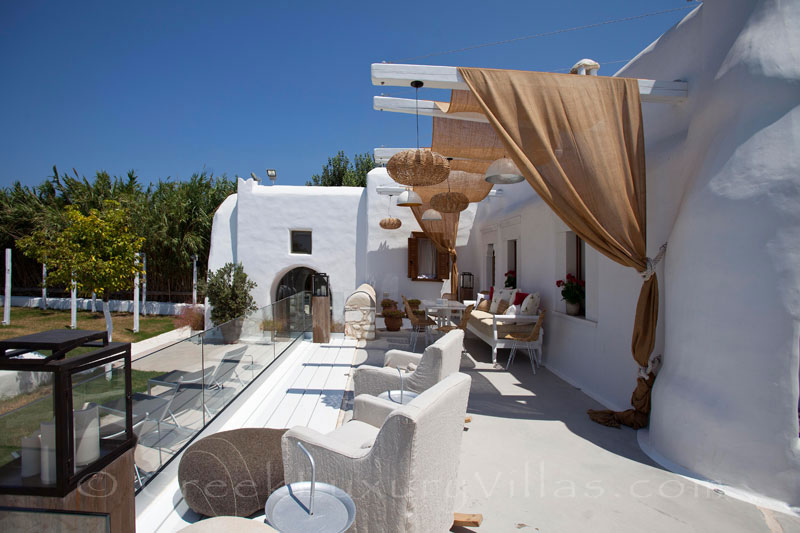 The veranda of a luxury villa with a pool