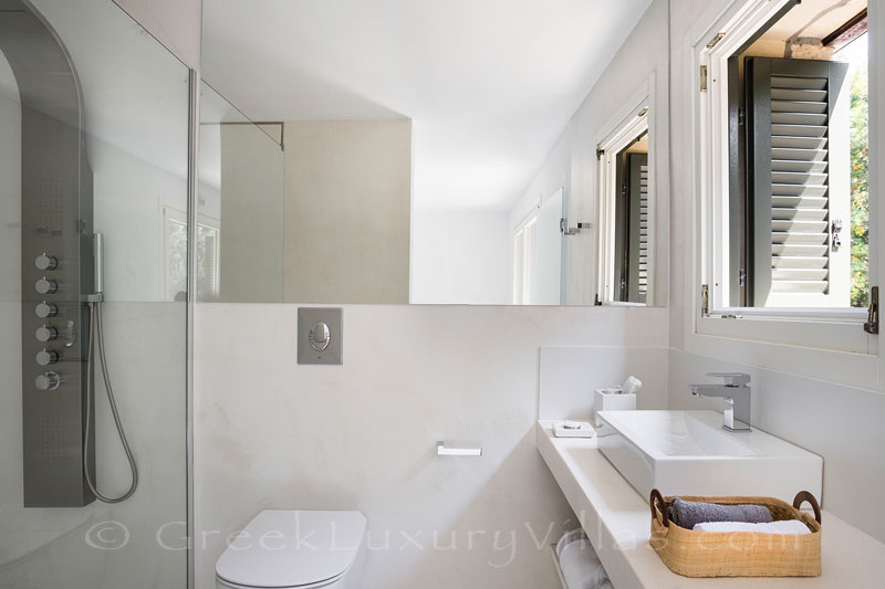 sunny bathroom at beachfront villa with tennis and pool