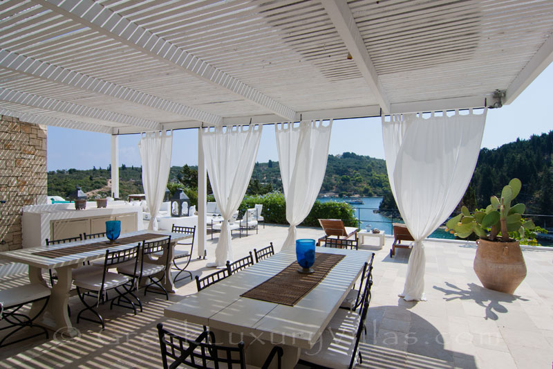 The outdoor dining area of a seafront luxury villa in Paxos where groups can dine together