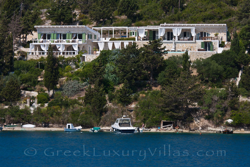 A waterfront luxury villa with a boat mooring in Paxos