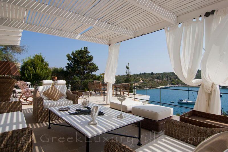 The seaside lounge of a seafront luxury villa for large groups in Paxos