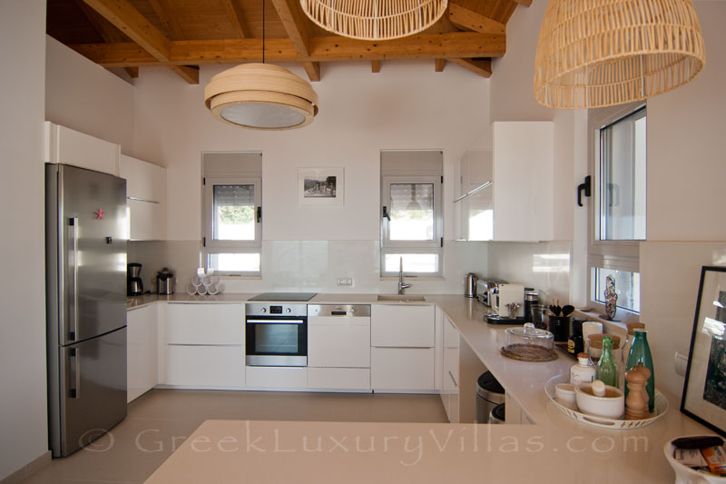 The kitchen of a modern luxury villa with a pool in Paxos