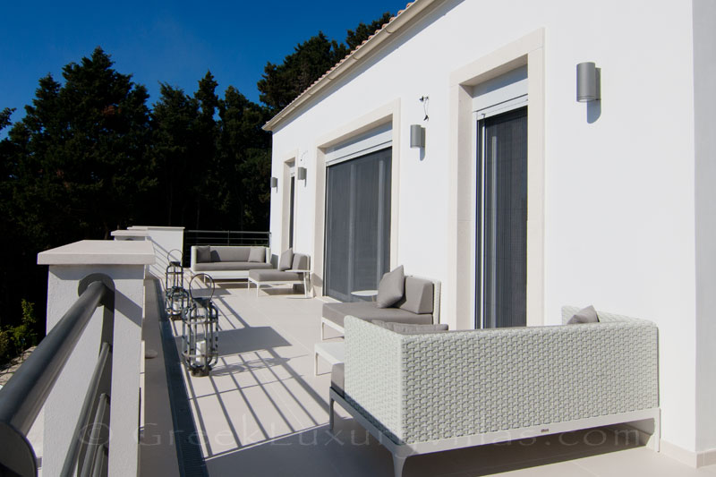 The balcony of the bedroom with seaview of a modern luxury villa with a pool in Paxos