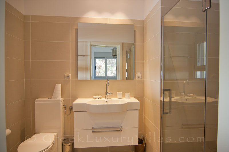 The bathroom of the guest house of a modern luxury villa with a pool in Paxos
