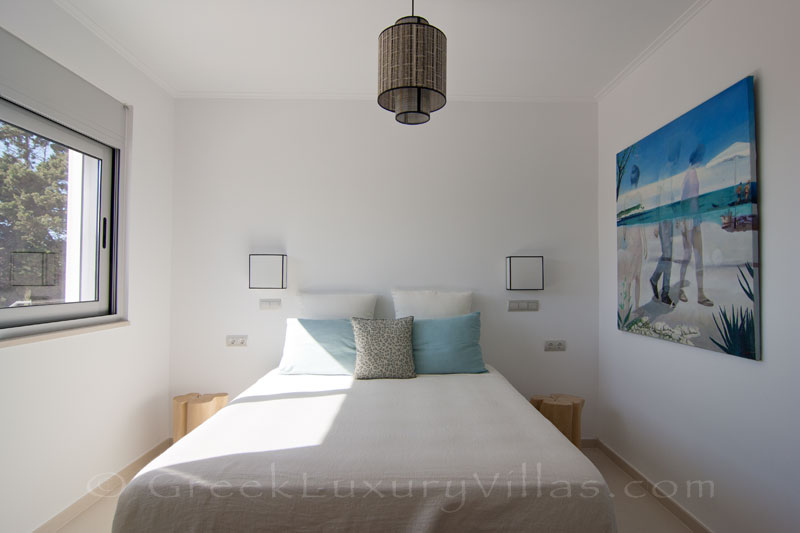 The bedroom of the guest house of a modern luxury villa with a pool in Paxos