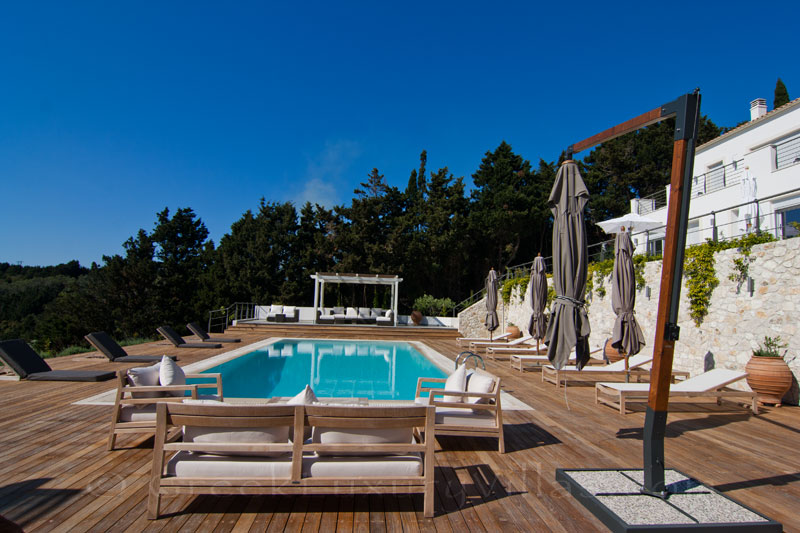 A big pool area with seaview in a modern luxury villa in Paxos