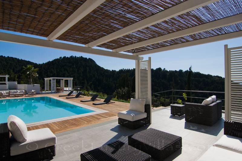 The lounge of the pool bar area of a modern luxury villa in Paxos with seaview
