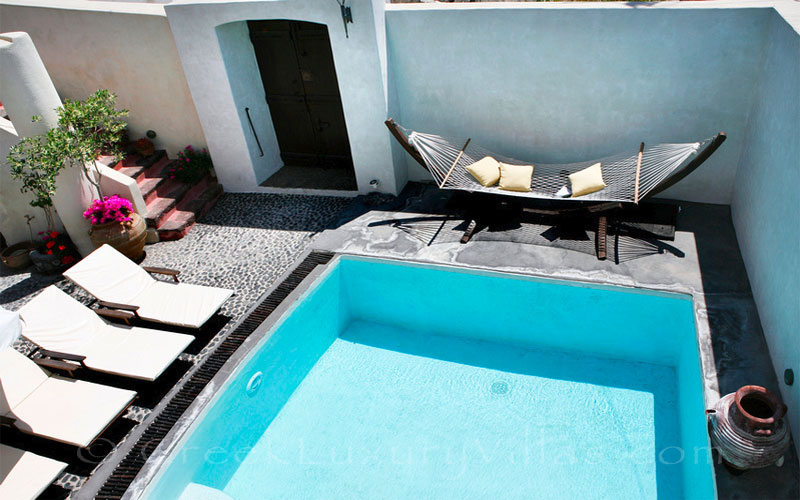 A traditional village in Santorini with a luxurious villa with a pool
