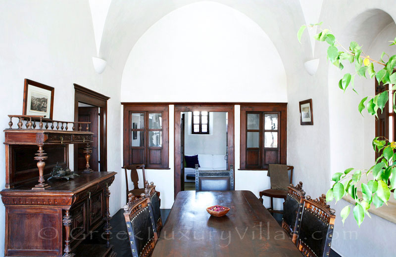 The luxurious dining room of a villa with a pool in a traditional village in Santorini