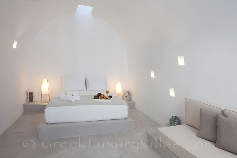 A cave bedroom in a contemporary luxury villa in Santorini
