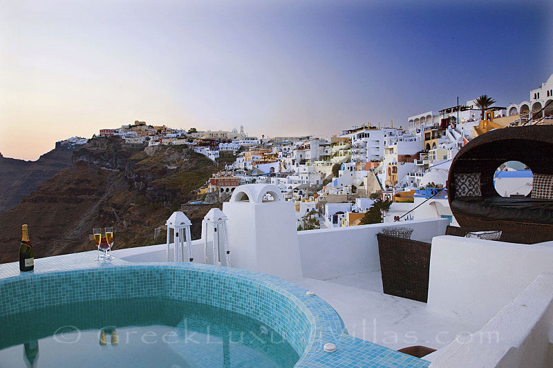 Sunset view from the rooftop jacuzzi of a luxury villa in Fira, Santorini