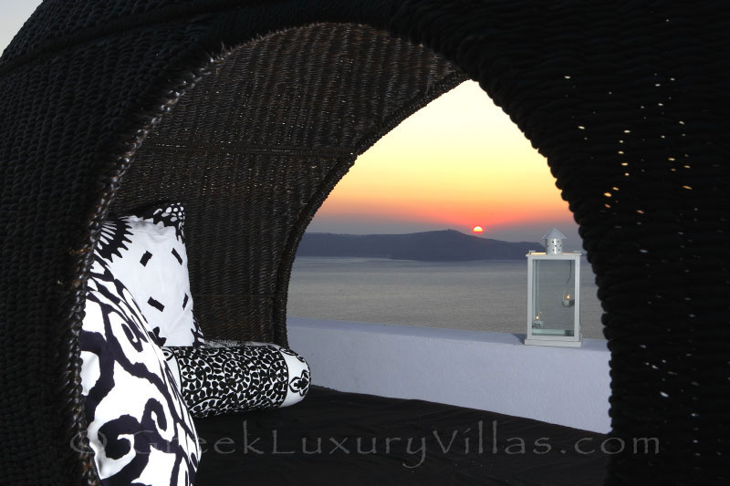 Sunset view from the rooftop jacuzzi of a luxury villa in Fira, Santorini