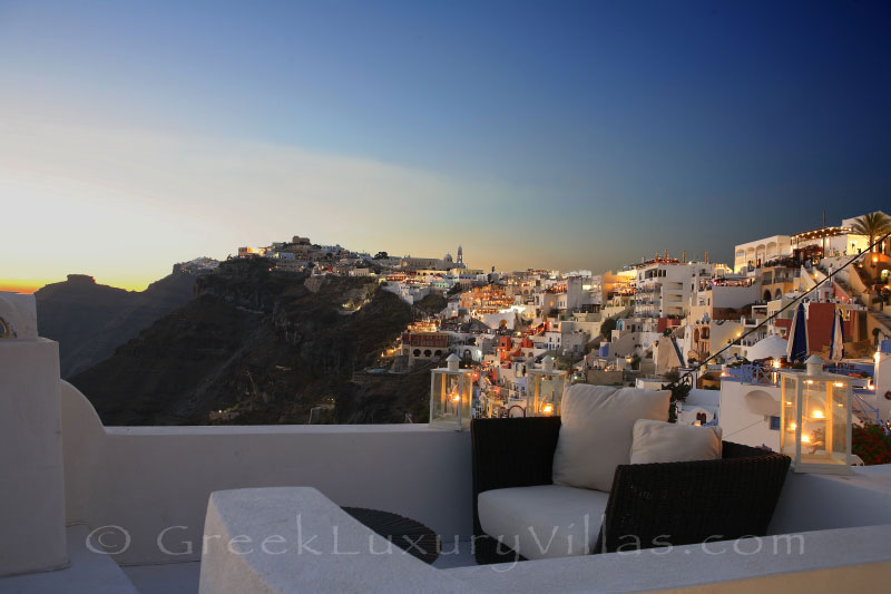 Sunset view from a rooftop jacuzzi of a luxury villa in Fira, Santorini