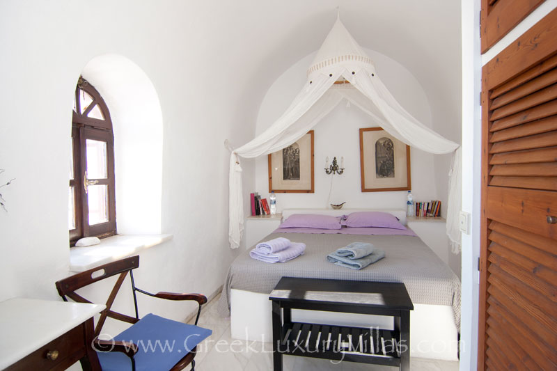 A bedroom with a chapel in large villa with a pool on the cliff in Santorini