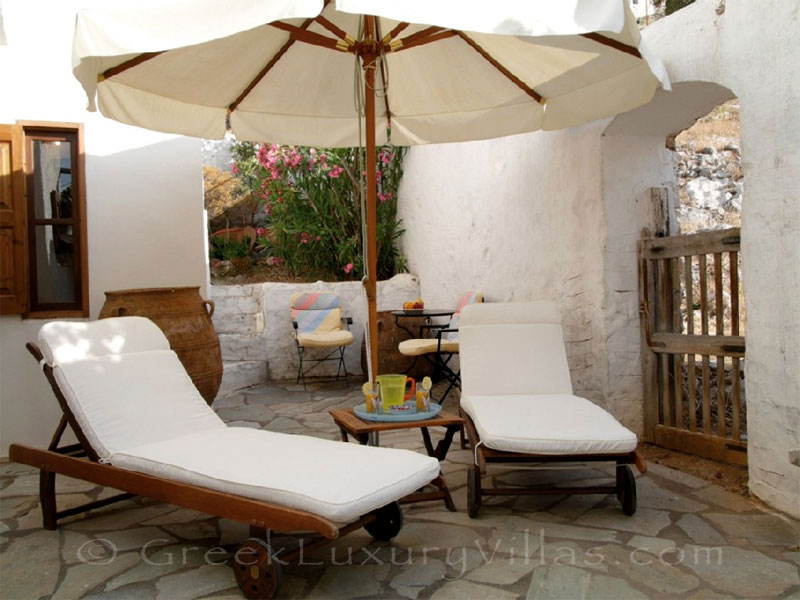 Relaxing on the sun loungers of the neoclassical villa in Symi