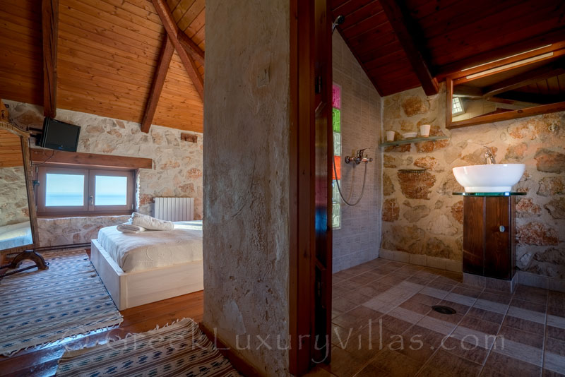 A bedroom of a seafront villa with a pool in Zakynthos