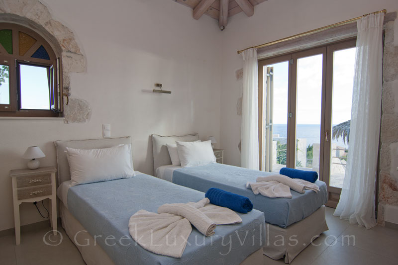 The bedroom of a seaview villa with a pool in Zante