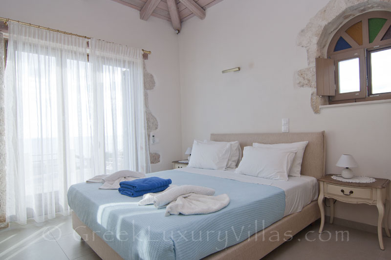 A bedroom of a seaview villa with a pool in ZANTE