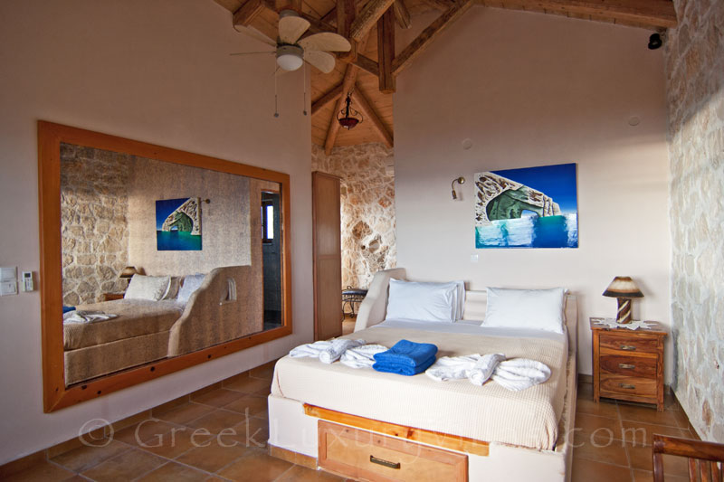 A bedroom of the villa with the pool and seaview